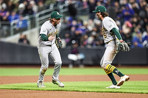 Jacob Wilson and Jeff McNeil celebrate during a double play