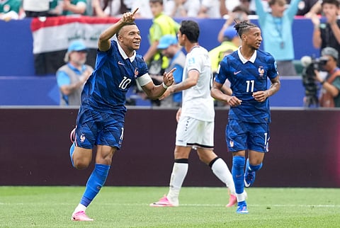 Kylian Mbappe celebrates after scoring the opening goal against Iraq