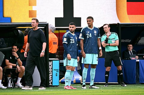 Julian Nagelsmann on the touchline with Malick Thiaw and Deniz Undav ready to come on