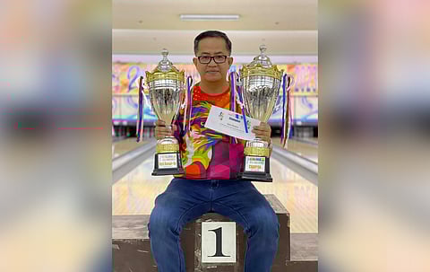 CHAMPION. Davao City bowler Edmund Cambaliza shows the open masters champion trophy and associate masters first runner-up trophy he won in the recently-concluded 2nd National Bowling Tour (NBT) held at the E-Lanes, Ortigas Avenue in San Juan City.
