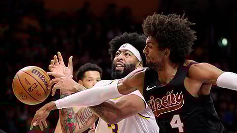 A.D.Portland Trail Blazers guard Matisse Thybulle, right, knocks the ball from the hands of Los Angeles Lakers forward Anthony Davis during the first half of an NBA basketball game Sunday, Nov. 12, 2023, in Los Angeles.
