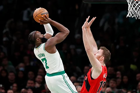 Boston Celtics' Jaylen Brown (7) shoots over Toronto Raptors' Jakob Poeltl (19) during the first half of an NBA basketball game, Saturday, Nov. 11, 2023, in Boston.
