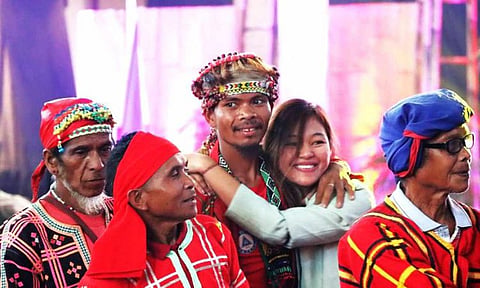 Former Guerilla Front 55 Secretary of the New People's Army Arian Jane Ramos, also known as Marikit, hugs Datu Tungig Mansumuy-at, former spokesperson of Pasakaday Salugpongan Kalimodan (Pasaka)-Southern Mindanao Region and former party member of the Communist Party of the Philippines (CPP), during the first anniversary celebration of an insurgency-free Davao Region in Davao City on October 28, 2023.