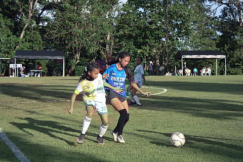 BALL BATTLE. Players from DCNHS-Khanj and Holy Child Red Eagles battle for the ball during their game in the 18th Acosta Cup ladies open football tournament at the Davao City-UP Mindanao Sports Complex field on Saturday, November 11, 2023.