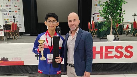 WORLD YOUTH BLITZ CHAMP. Philippines’ Fide master (FM) Christian Gian Karlo Tade Arca, hailing from Panabo City, Davao del Norte, receives his blitz champion’s trophy from an organizing official of the Fide World Youth Chess Championships in Montesilvano, Italy Wednesday, November 22 (Philippine time).