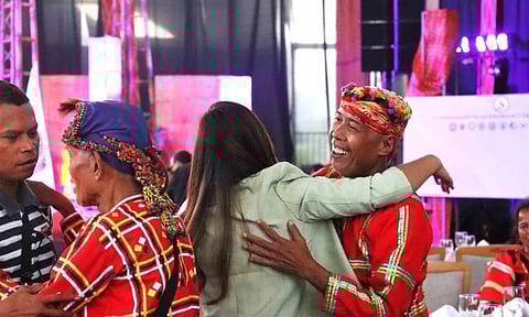 Former Guerilla Front 55 Secretary of the New People's Army Arian Jane Ramos, also known as Marikit, hugs Datu Onie Bongkalas, a former staff of Salugpongan Ta’tanu Igkanugon Community Learning Center Inc. (STTICLCI) and former party member of the Communist Party of the Philippines (CPP), during the first anniversary celebration of an insurgency-free Davao Region in Davao City on October 28, 2023.