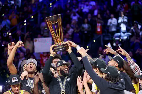 CHAMPS. Los Angeles Lakers forward LeBron James, center, lifts the NBA Cup while celebrating with teammates after they defeated the Indiana Pacers 123-109 in the championship game in the NBA basketball In-Season Tournament on Saturday, Dec. 9, 2023, in Las Vegas.