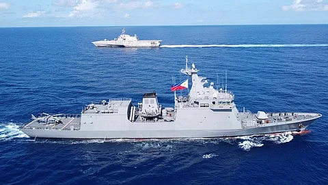 Philippine forces sail to hotly disputed shoal without incident for first time since deal with China