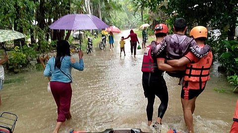 Personnel from the Bureau of Fire Protection are actively engaged in a rescue operation in Barangay San Miguel, Cateel, Davao Oriental in response to the heavy rain and flooding on Tuesday, January 30, 2024.