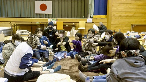 LOCAL residents in the quake-hit area stretch out together at a shelter in Anamizu, Ishikawa prefecture, Sunday, Jan. 7, 2024. / KYODO NEWS VIA AP
