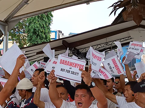RALLY VS CHA-CHA. Protesters from Calinan District express disapproval of the People's Initiative for Charter Change by chanting, "Dabawenyos are not for sale." They raise flaglets with the same message at Rizal Park, Davao City, on January 19, 2024