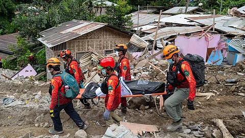 Rescuers carry a body from the landslide-hit village of Masara in Maco, Davao de Oro province, southern Philippines on Thursday Feb. 8, 2024.