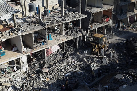 Palestinians look at the destruction after an Israeli strike on residential buildings and a mosque in Rafah, Gaza Strip, Thursday, Fe. 22, 2024