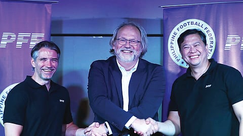 NEW GAFFER. Tom Saintfiet, the new coach of the men's national team, joins manager Freddy Gonzales (left) and Philippine Football Federation president John Guttierrez (right) during his media presentation.