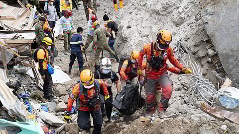 DAVAO DE ORO. Rescuers carry a body from the landslide-hit village of Masara in Maco, Davao de Oro province, southern Philippines on Thursday, February 8, 2024.