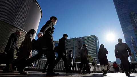 Commuters walk in a passageway during a rush hour at Shinagawa Station on Wednesday, February 14, 2024, in Tokyo. Japan has slipped to the world’s fourth-largest economy as government data released Thursday, February 15, 2024, showed it fell behind the size of Germany in 2023.