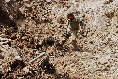 An Army Rescuer with a K9 conduct the Search, Rescue and Retrieval operations in Davao de Oro.