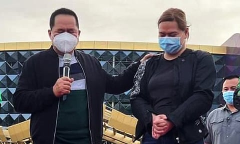 Pastor Apollo Quiboloy prays over then-Davao City Mayor and Vice presidential aspirant Sara Duterte as she kicks off her nationwide caravan dubbed as "Mahalin Natin Ang Pilipinas Ride" in Davao City on February 1, 2022.