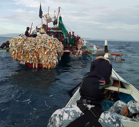 ZAMBOANGA. Personnel of the Philippine Coast Guard (PCG) and policemen seize two motorboats they caught engaged in illegal fishing in the municipal waters of Kabasalan, Zamboanga Sibugay on Tuesday, February 27, 2024. A photo handout shows PCG and police aboard a watercraft approaching one of the two motorboats they caught fishing illegally.
