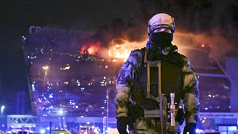A RUSSIAN Rosguardia (National Guard) serviceman secures an area amid a massive blaze seen over the Crocus City Hall on the western edge of Moscow, Russia, Friday, March 22, 2024. Several gunmen burst into the big concert hall in Moscow, fired automatic weapons at the crowd and set a massive blaze in an apparent terror attack that has killed at least 115 people. / AP