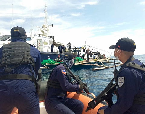 ZAMBOANGA. Philippine Coast Guard (PCG) personnel manning the Monitoring, Control, and Surveillance (MCS)-3001 of the Bureau of Fisheries and Aquatic Resources (BFAR), apprehend an unmarked motorboat for illegal fishing in the vicinity of waters of Zamboanga Sibugay and Malasugat Bays on Tuesday, March 26. A photo handout shows PCG personnel aboard a rubberized inflatable boat watching while their comrades inspected the apprehended motorboat.