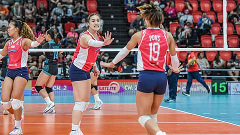 EASY WIN. Creamline’s Michelle Gumabao celebrates with her teammate, Bernadeth Pons, after the Cool Smashers scored a point against the Galerie Towers. / PVL
