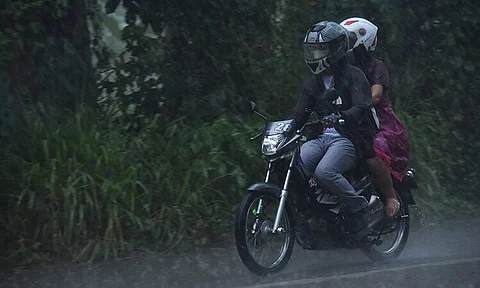 FORWARD TOGETHER. These motorists traversing through Tacunan, Davao City were met with heavy rain but still they decided to push through with their travel.