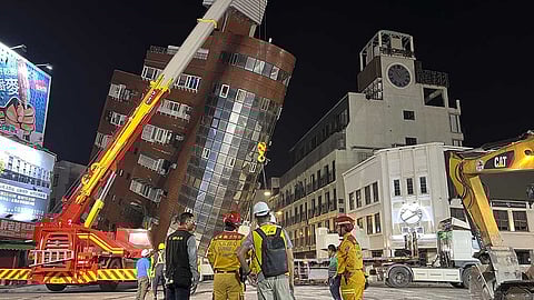 TAIWAN. Rescue workers stand near the site of a leaning building in the aftermath of an earthquake in Hualien, eastern Taiwan on Wednesday, April 3, 2024.