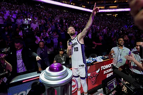 Sacramento Kings forward Domantas Sabonis (10) lights the beam after the team's victory over the Golden State Warriors in an NBA basketball play-in tournament game Tuesday, April 16, 2024, in Sacramento, California.