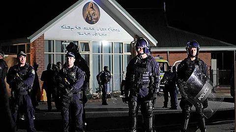 FILE - Security officers stand guard outside Orthodox Assyrian church in Sydney, Australia, April 15, 2024. Four teenagers plotted to buy guns and attack Jewish people days after a bishop was stabbed in a Sydney church, according to police documents cited in news reports on Monday, April 29, 2024. 