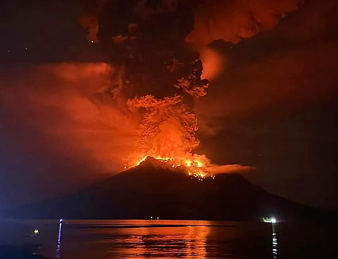 In this photo released by Sitaro Regional Disaster Management Agency (BPBD Sitaro), hot molten lava glows at the crater of Mount Ruang as it erupts in Sanguine Islands, Indonesia, Wednesday, April 17, 2024. Indonesian authorities issued a tsunami alert Wednesday after eruptions at Ruang mountain sent ash thousands of feet high. Officials ordered more than 11,000 people to leave the area.