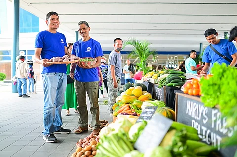 Jayson and Juanito proudly showcase a selection of produce at the SM City Clark’s Weekend Market.