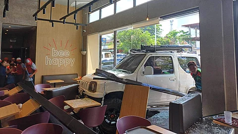 A GLASS wall panel of Jollibee in Moalboal, southwestern Cebu was destroyed after a vehicle rammed into it on Thursday morning, April 11, 2024. A diner was injured during the incident. /