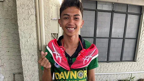 NEW SPIKES. Lorenz Datiles of Sto. Tomas, Davao del Norte, the most decorated track and field athlete of the Davao Region Athletic Association (Davraa) Meet 2024 and the owner of `FrankenSpikes,’ beams with joy as he poses with his new track shoes, gifted by a generous donor. 