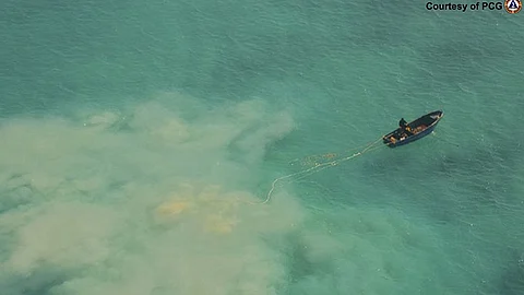 MANILA. In this April 22, 2019 handout photo provided by the Philippine Coast Guard, Chinese service boats scour the seabed as they search for giant clams in the Scarborough shoal, at the disputed South China Sea, the Philippine Coast Guard said.