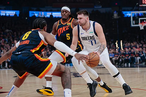 Dallas Mavericks guard Luka Doncic (77) drives against Oklahoma City Thunder forward Jalen Williams (8) and guard Luguentz Dort (5) during the first half of Game 5 of an NBA basketball second-round playoff series, Wednesday, May 15, 2024, in Oklahoma City.