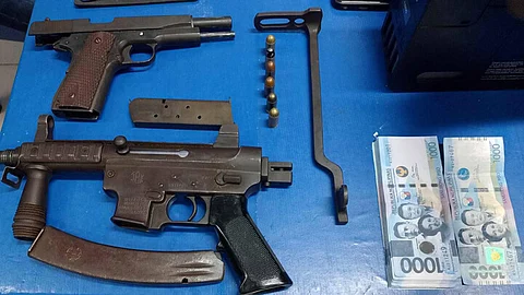 ZAMBOANGA. Policemen arrest two preachers for gun trafficking on Saturday, May 18, 2024, along the Diversion Road at Purok Gumamela in Taway village, Ipil, the capital town of Zamboanga Sibugay province. A photo handout shows the unlicensed guns seized from the arrested two preachers.