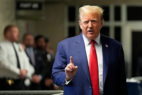 Former President Donald Trump speaks to members of the media before entering the courtroom at Manhattan criminal court, Monday, May 6, 2024, in New York.