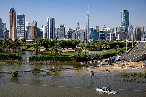 An abandoned vehicle stands in floodwater caused by heavy rain with the Burj Khalifa, the world's tallest building, seen on the background, in Dubai, United Arab Emirates, on April 18, 2024. Dubai Airports announced on Thursday, May 2, the cancelation and diversion of flights due to unsettled weather conditions in the United Arab Emirates.