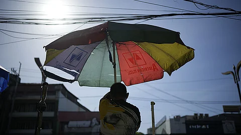 MANILA. A vendor prepares his umbrella as hot days continue in Manila, Philippines on Monday, April 29, 2024.