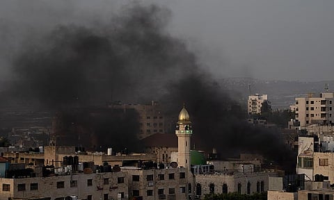 Black smokes rise to the sky during clashes between Israeli forces and Palestinians demonstrators in the West Bank city of Jenin, Wednesday, May 22, 2024.