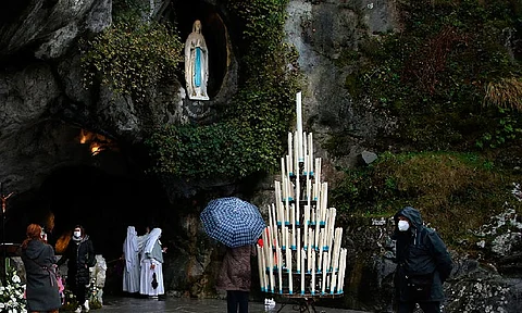 Pilgrims pray at the Roman Catholic shrine in Lourdes, southwestern France, Friday, Feb.11, 2022. On Friday, May 17, 2024, the Vatican will issue revised norms for discerning apparitions "and other supernatural phenomena," updating a set of guidelines first issued in 1978.