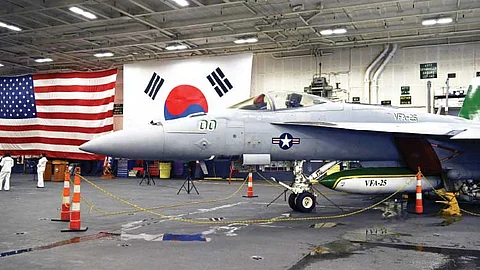 AN F-18 FIGHTER aircraft sits in the hanger of the Theodore Roosevelt, a nuclear-powered aircraft carrier, anchored in Busan Naval Base in Busan, South Korea Saturday, June 22, 2024. / SONG KYUNG-SEOK/POOL PHOTO VIA AP