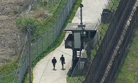 South Korean army soldiers patrol along the barbed-wire fence in Paju, South Korea, near the border with North Korea, on April 23, 2024. South Korean soldiers fired warning shots after North Korean troops violated the land border earlier this week, South Korea's military said Tuesday, June 11.