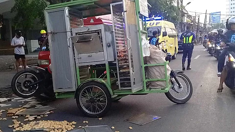 Bread scatter on the road after passenger jeepney hit a mobile bakery