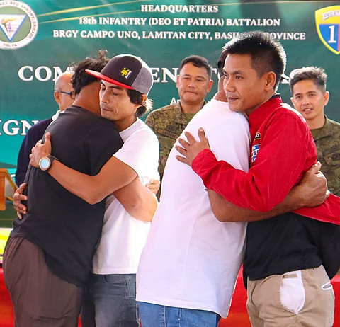 ZAMBOANGA. The municipality of Akbar in Basilan province is now a rido-free place as authorities facilitate the peaceful settlement of the sole clan feud in that town on Wednesday, June 5. A photo handout shows the family members of Gamal Antih, chairperson of Linungan village, and Benhar Jabbar, residents of the same village, embracing each other after they signed the peace covenant witnessed by top government and military officials.
