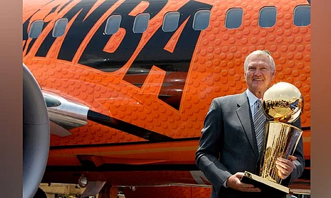 Former Los Angeles Lakers and Basketball Hall of Fame member Jerry West holds the Larry O'Brien championship trophy after it arrived at Los Angeles International Airport, on a Southwest Airline, NBA-branded 737 named "Slam Dunk One,'' Monday, June 9, 2008, in Los Angeles. Jerry West, who was selected to the Basketball Hall of Fame three times in a legendary career as a player and executive and whose silhouette is considered to be the basis of the NBA logo, died Wednesday morning, June 12, 2024, the Los Angeles Clippers announced. He was 86.
