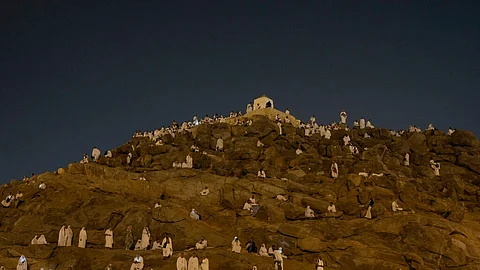 Muslim pilgrims gather at top of the rocky hill known as the Mountain of Mercy, on the Plain of Arafat, during the annual Hajj pilgrimage, near the holy city of Mecca, Saudi Arabia, Saturday, June 15, 2024.