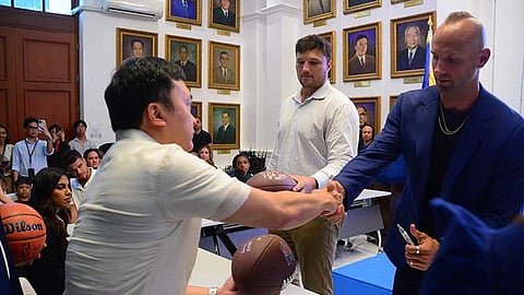 MANILA. Department of Justice Undersecretary Nicholas Felix L. Ty (left) shakes hands with IJM’s Mark Herzlich, as Tennessee Titans’ Dillon Radunz (standing) looks on.