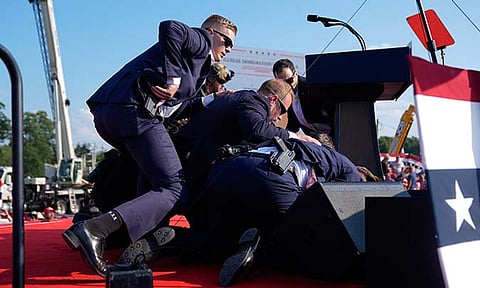 Republican presidential candidate former President Donald Trump is covered by U.S. Secret Service agents at a campaign rally, Saturday, July 13, 2024, in Butler, Pa.